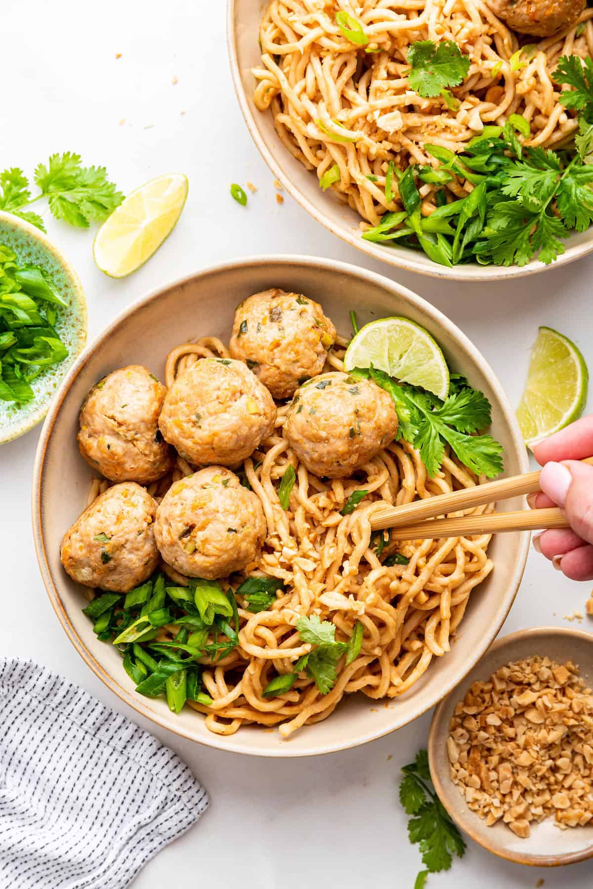 Two bowls of peanut noodles with Asian turkey meatballs