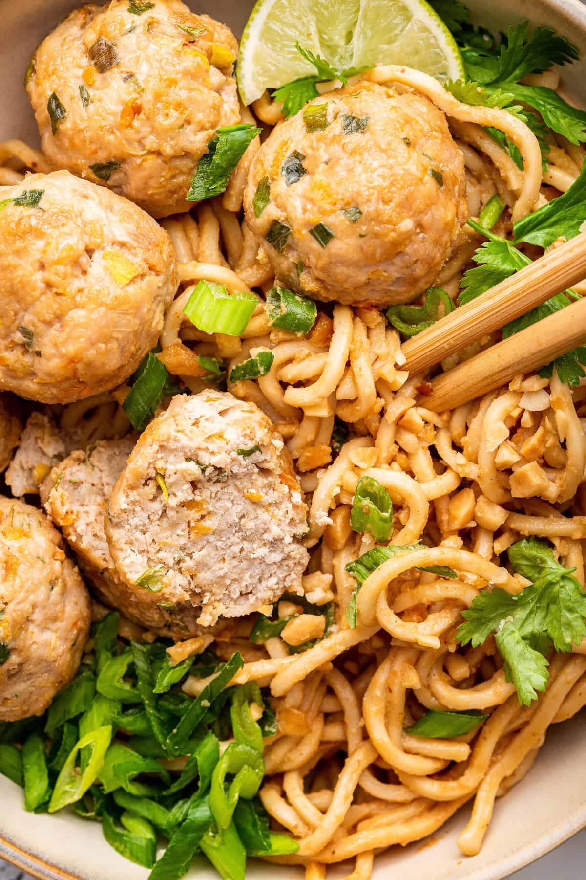 Juicy Asian turkey meatballs in bowl with noodles and chopsticks