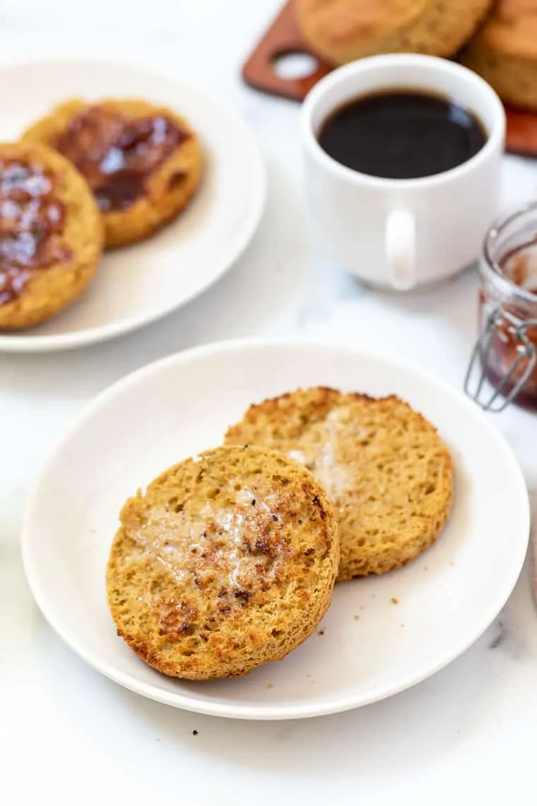 Plate with toasted and buttered gluten-free English muffin