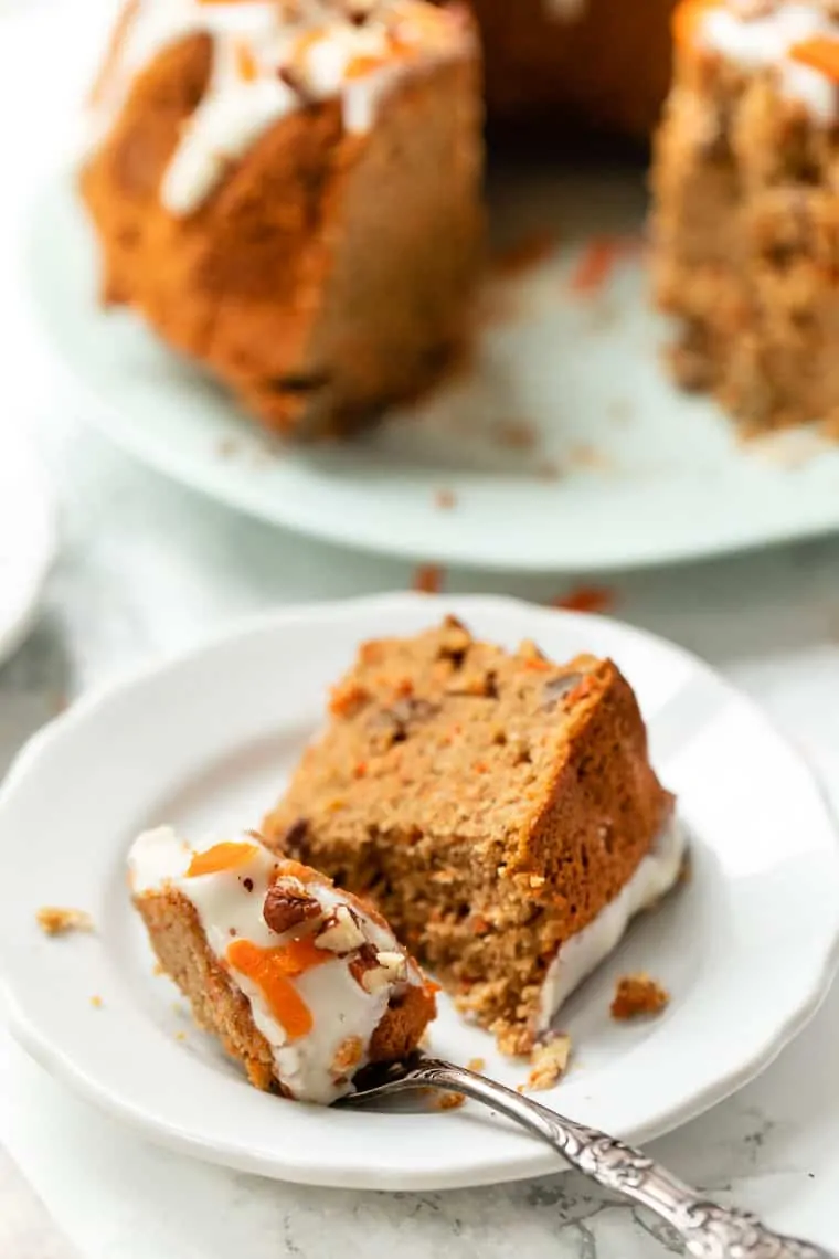 Slice of gluten-free carrot cake on plate with fork