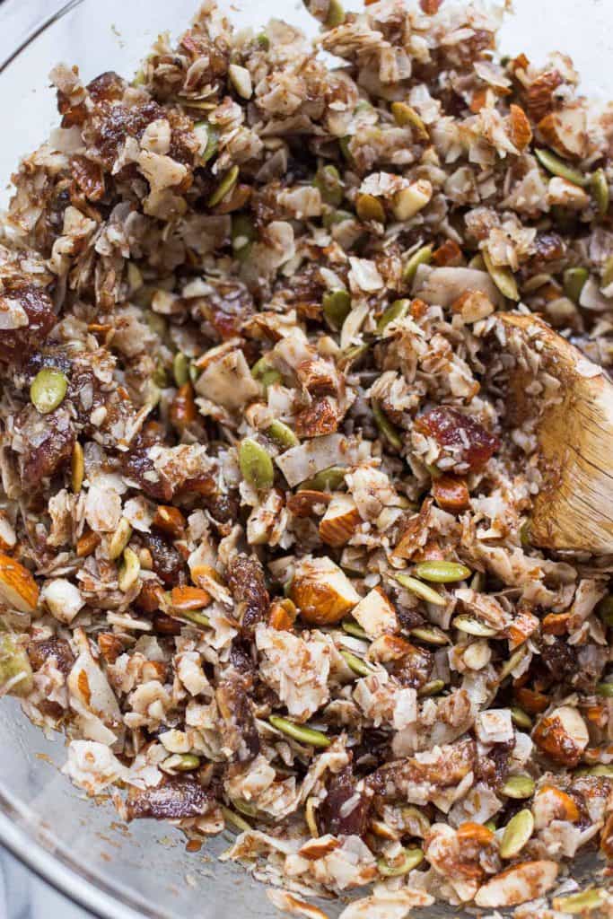 Bowl of coconut granola being mixed with spoon