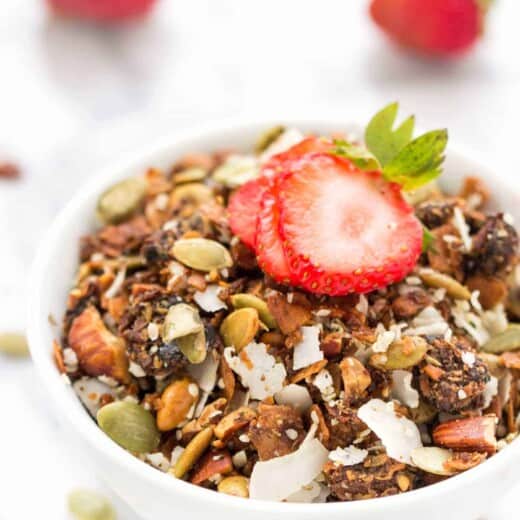 Coconut granola in bowl with strawberry on top