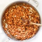 Overhead view of BBQ vegan pulled pork in skillet with wooden spoon