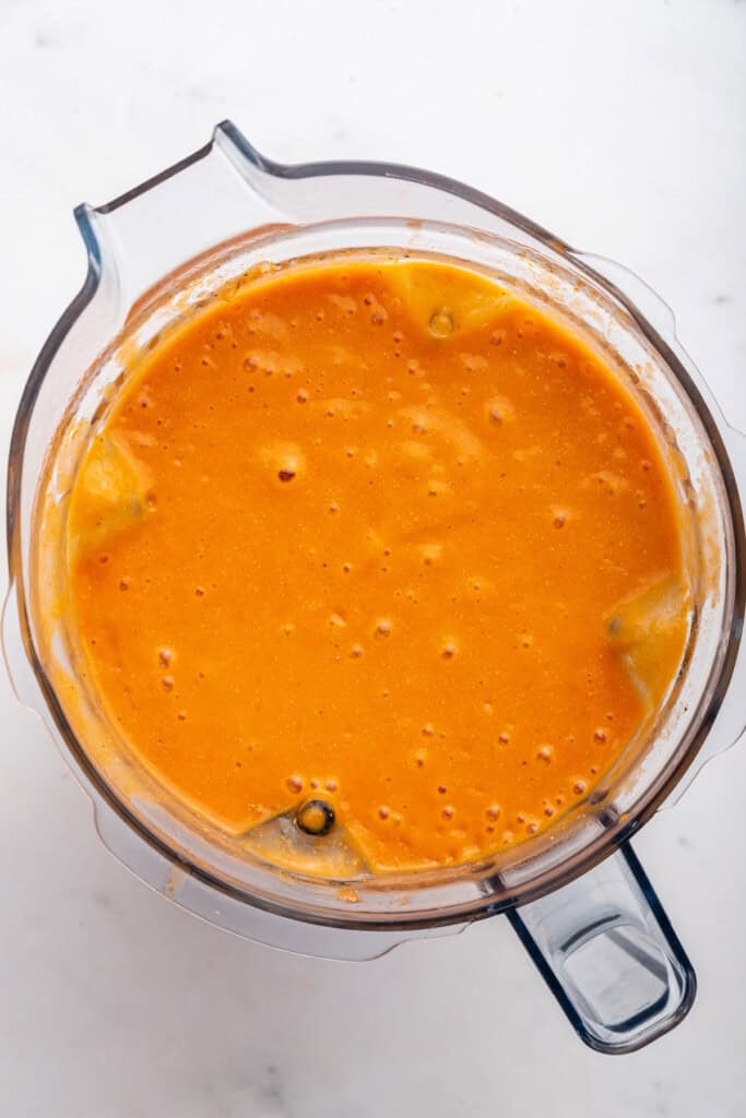 Blended tomato bisque soup in a blender.