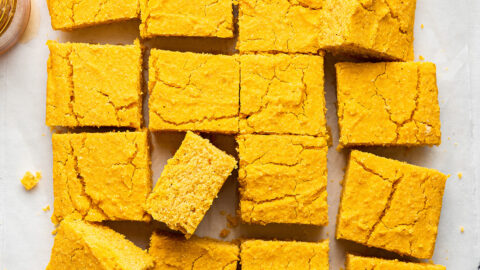 Overhead view of vegan pumpkin cornbread, cut into squares, all separated slightly