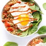 Overhead photo of savory breakfast quinoa with a runny fried egg on top.