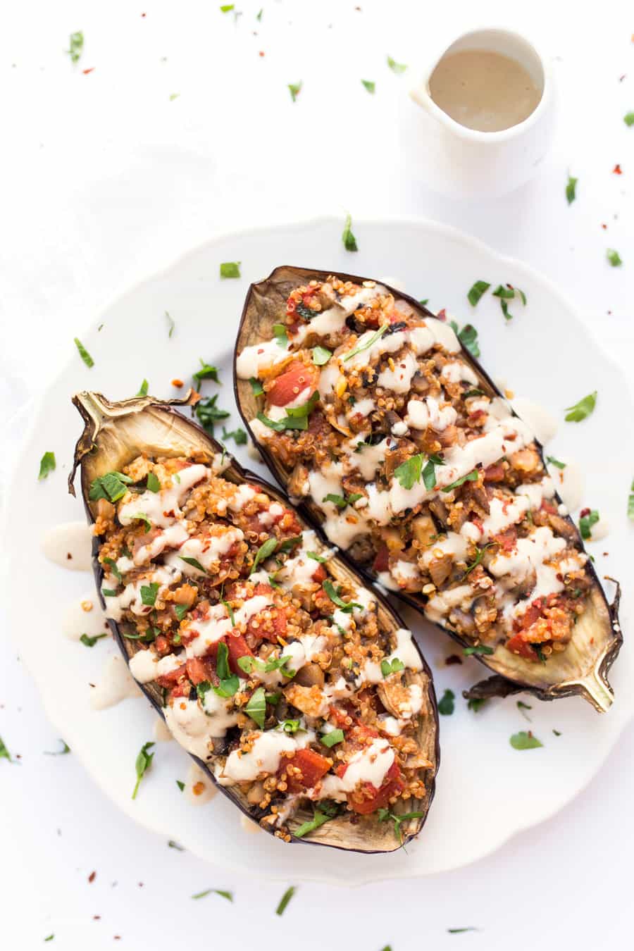 Quinoa Stuffed Eggplant - with mushrooms, tomatoes and a creamy tahini sauce on top! Ready in just 30 MINUTES!