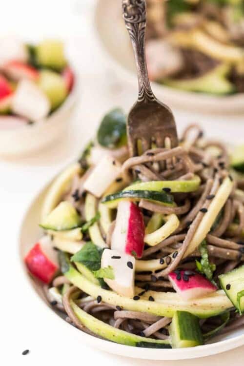 Fork twirling sesame soba noodles on plate