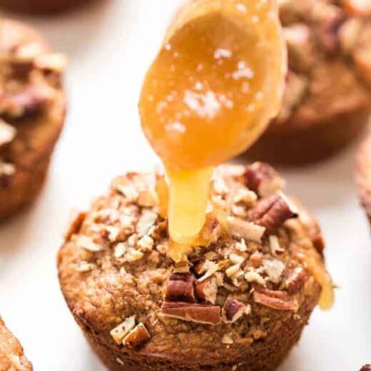 Drizzling honey onto blender muffin with applesauce