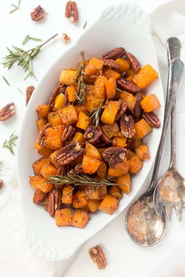 Overhead view of maple roasted butternut squash with pecans and rosemary