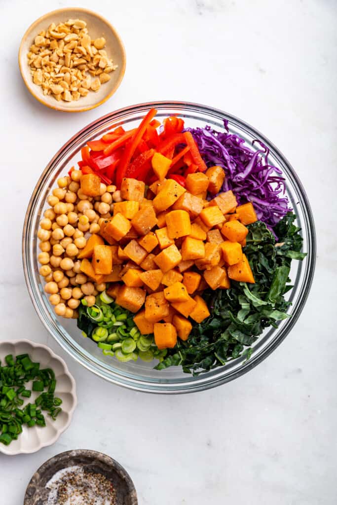 Overhead view of ingredients for kale sweet potato salad in mixing bowl