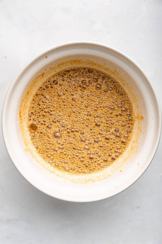 Overhead view of wet ingredients mixed in bowl