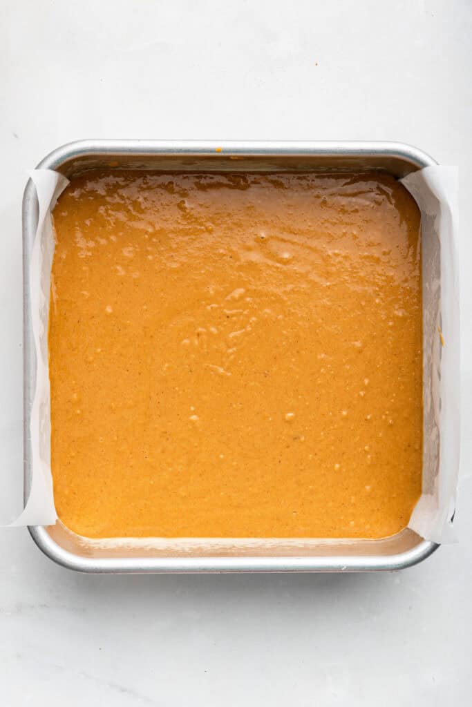 Overhead view of pumpkin coffee cake batter in pan