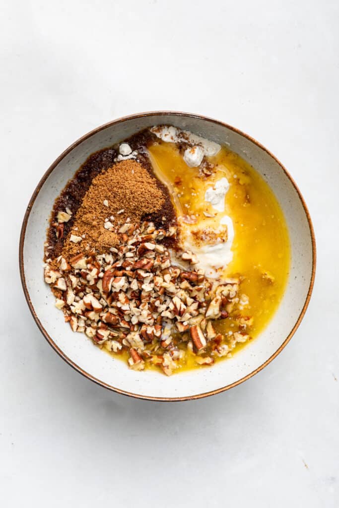 Overhead view of ingredients for pecan crumb topping in bowl