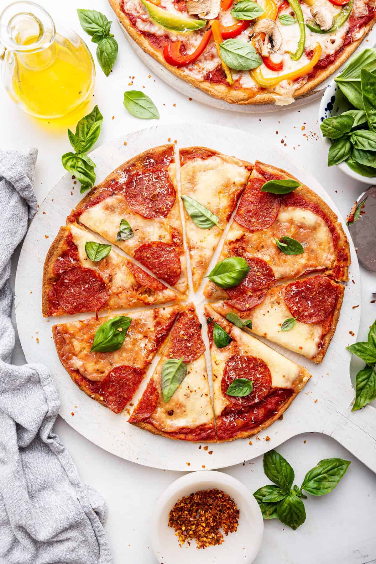 Sliced pepperoni almond flour pizza garnished with basil