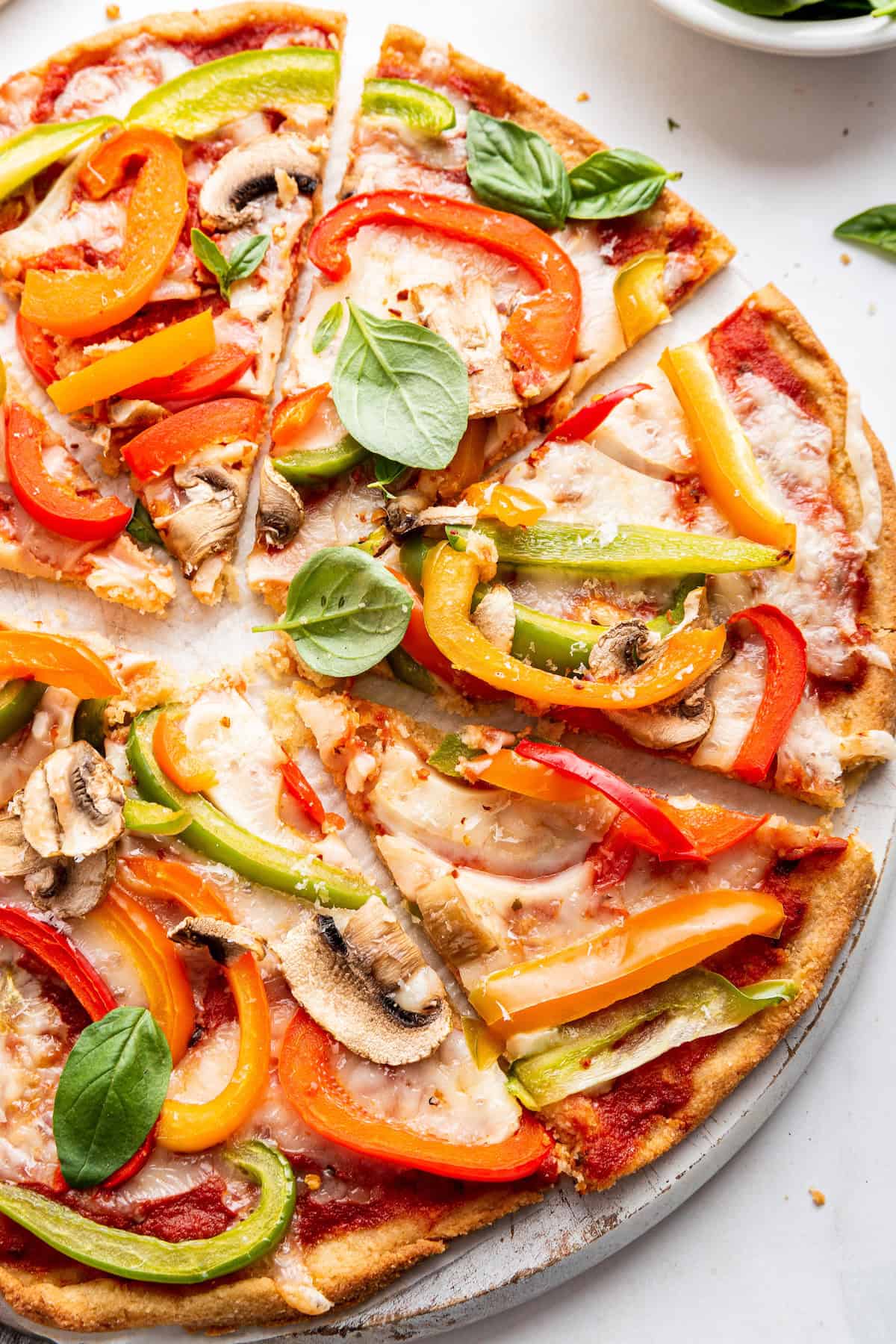 Overhead view of almond flour pizza with veggies