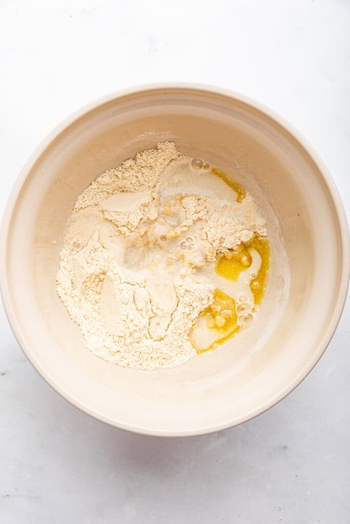 Overhead view of ingredients for almond flour pizza crust before mixing