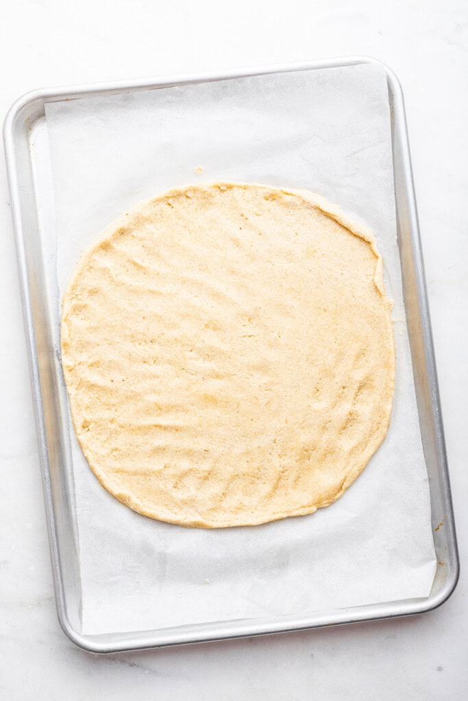 Overhead view of unbaked almond flour pizza crust