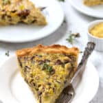 Dairy-free mushroom quiche slice on plate with fork