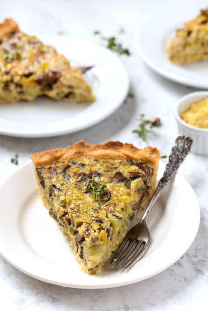 Dairy-free mushroom quiche slice on plate with fork