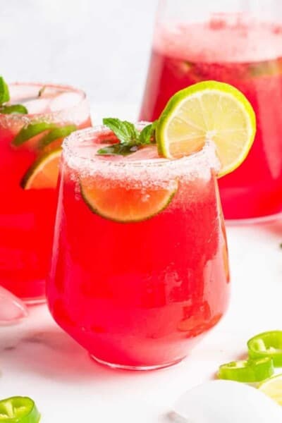 glass of watermelon margarita with lime juice and a salt rim