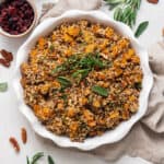 white plate of quinoa stuffing with fresh herbs