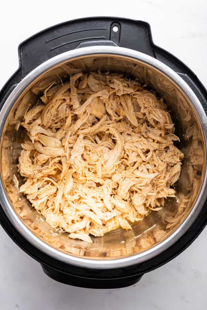 Overhead view of shredded chicken in Instant Pot