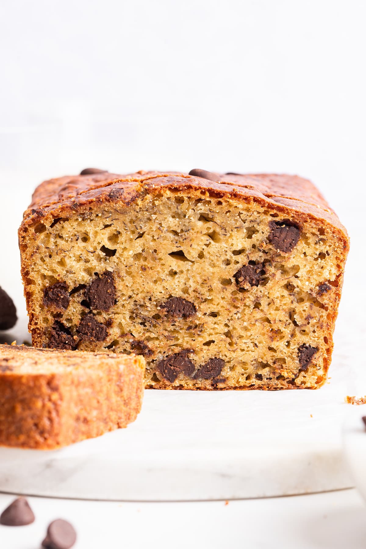 Protein banana bread loaf cut to show moist interior and chocolate chips