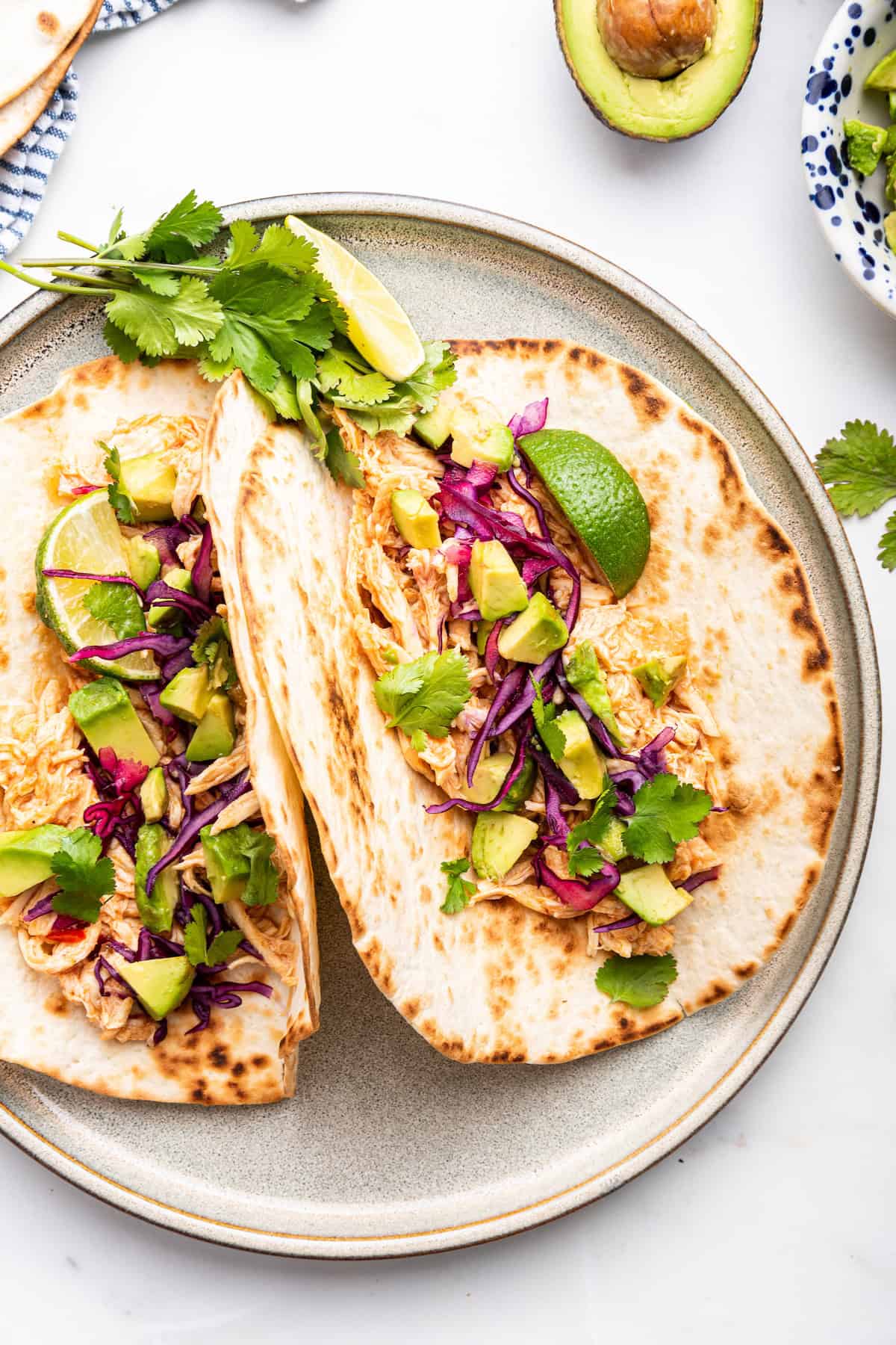 Overhead view of shredded chicken tacos on plate