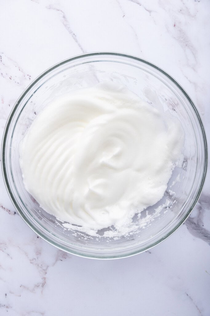 Beaten egg whites in mixing bowl