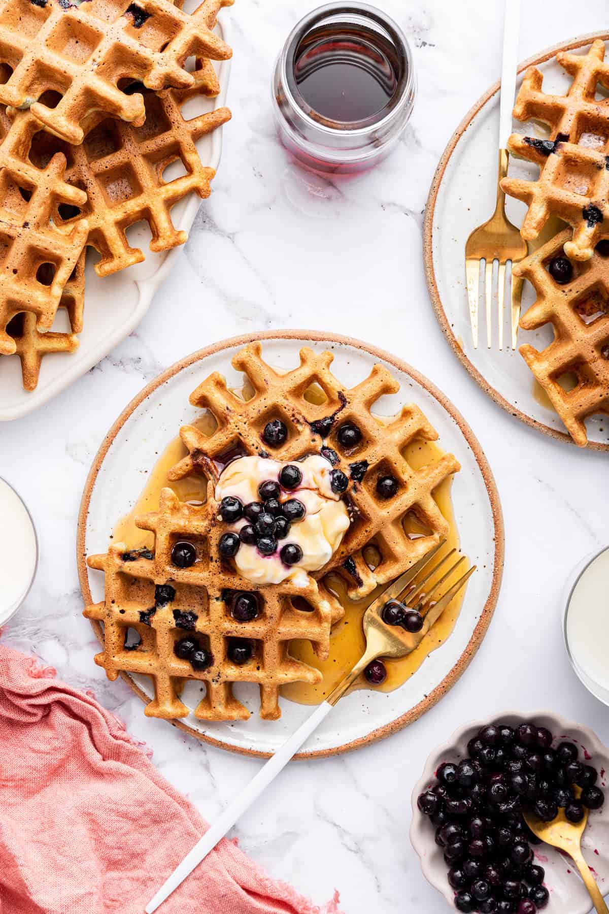 Overhead view of blueberry waffles on plates