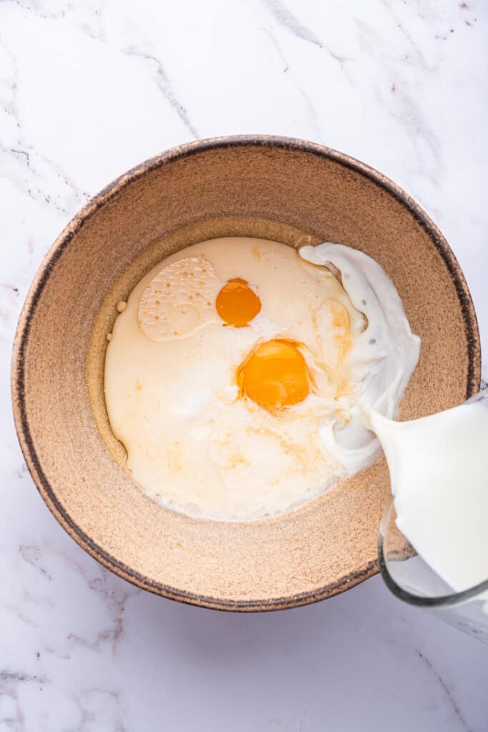 Pouring milk into bowl of wet ingredients