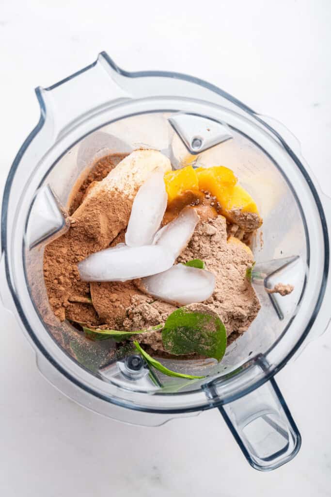 Overhead view of chocolate peanut butter smoothie ingredients in blender