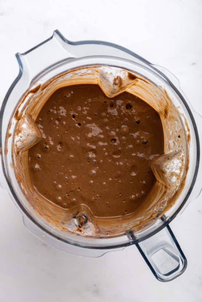 Overhead view of chocolate peanut butter smoothie in blender