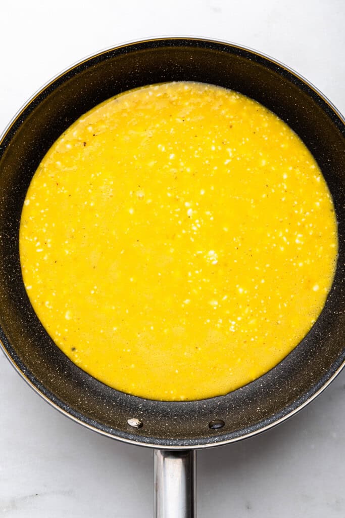 Overhead view of cottage cheese egg mixture in skillet