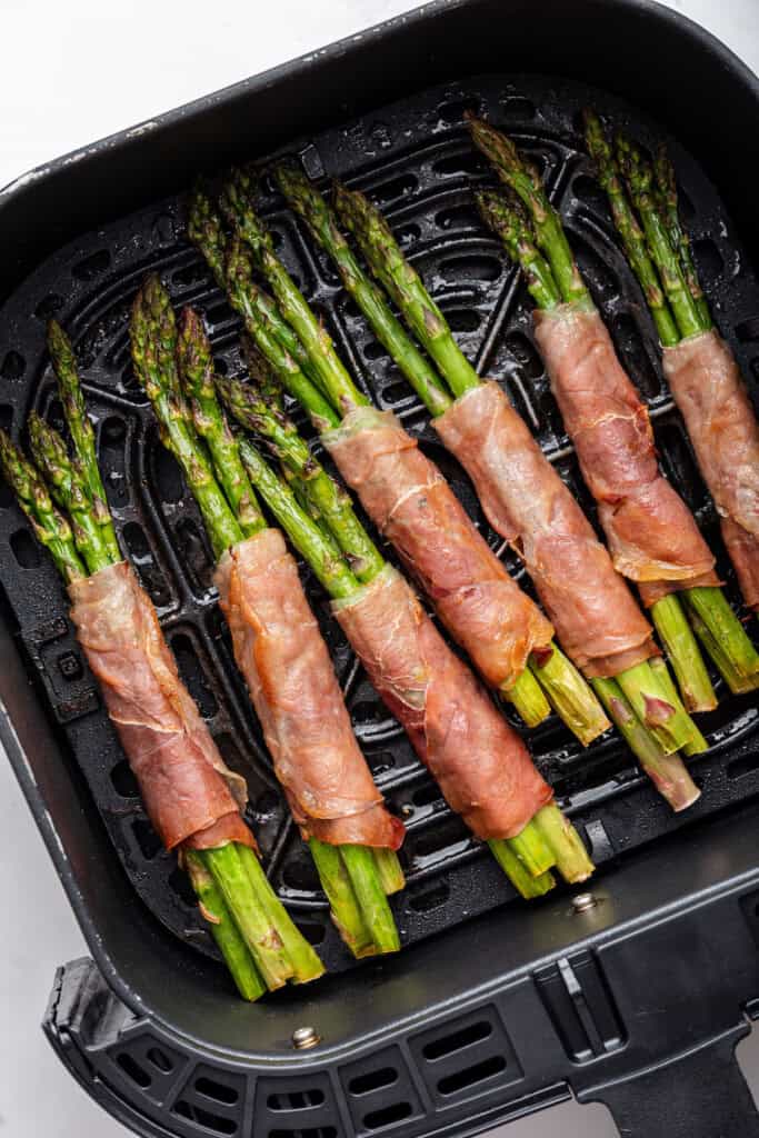 Prosciutto wrapped asparagus in air fryer basket