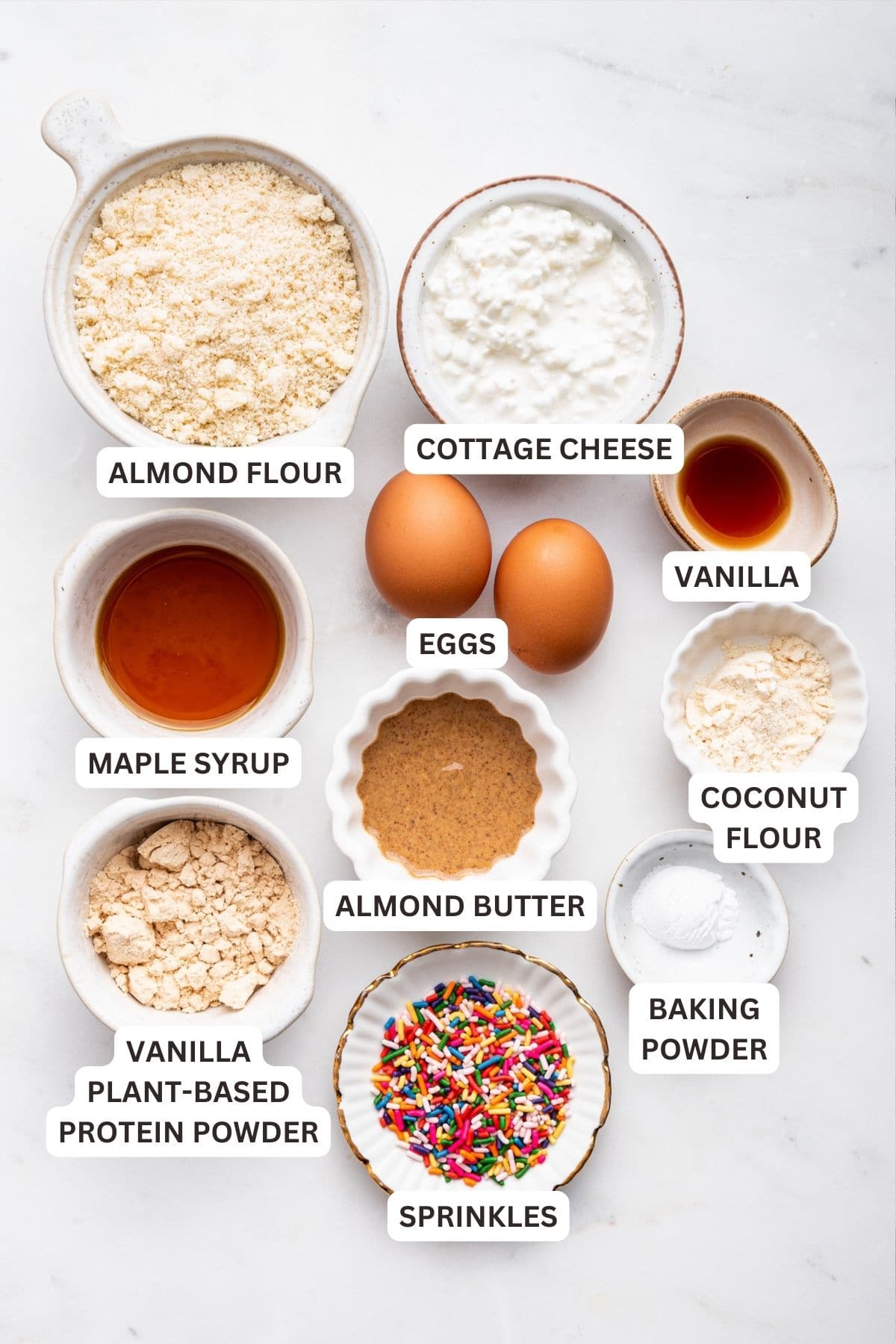 Overhead view of protein mug cake ingredients with labels