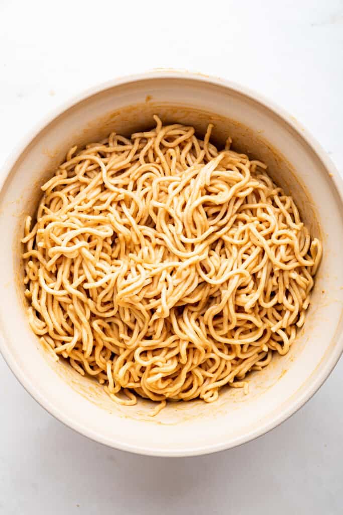 Overhead view of peanut noodles in large bowl