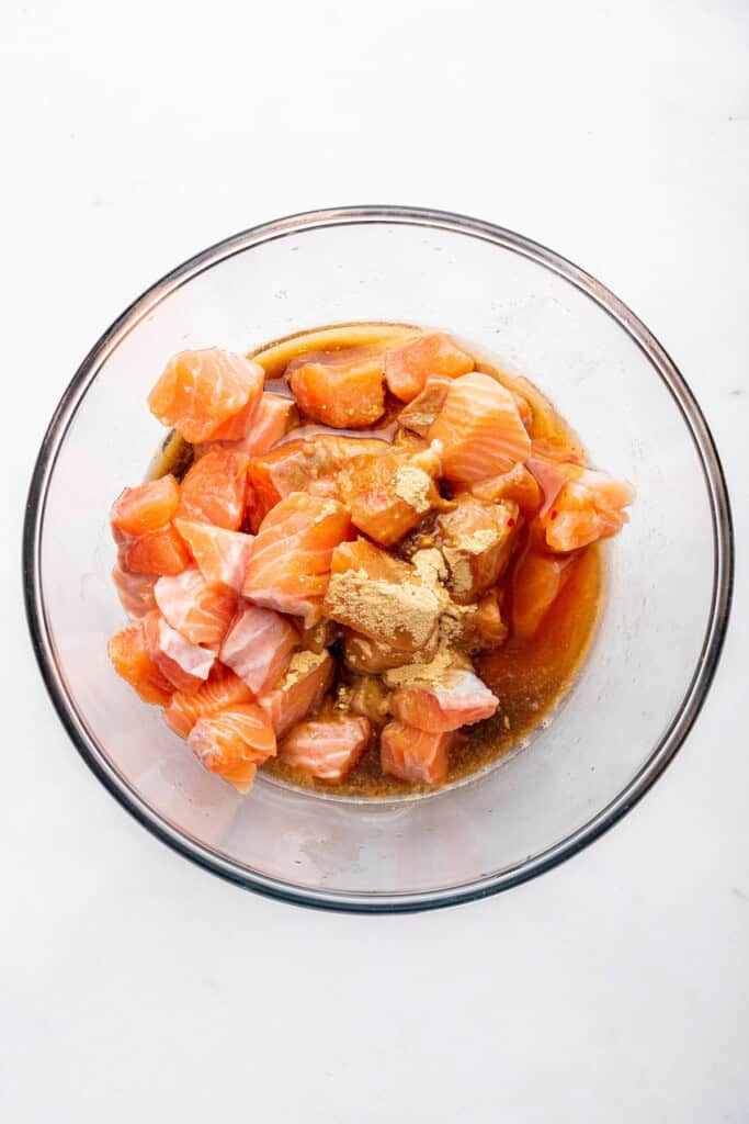 Overhead view of salmon with sauce ingredients in bowl