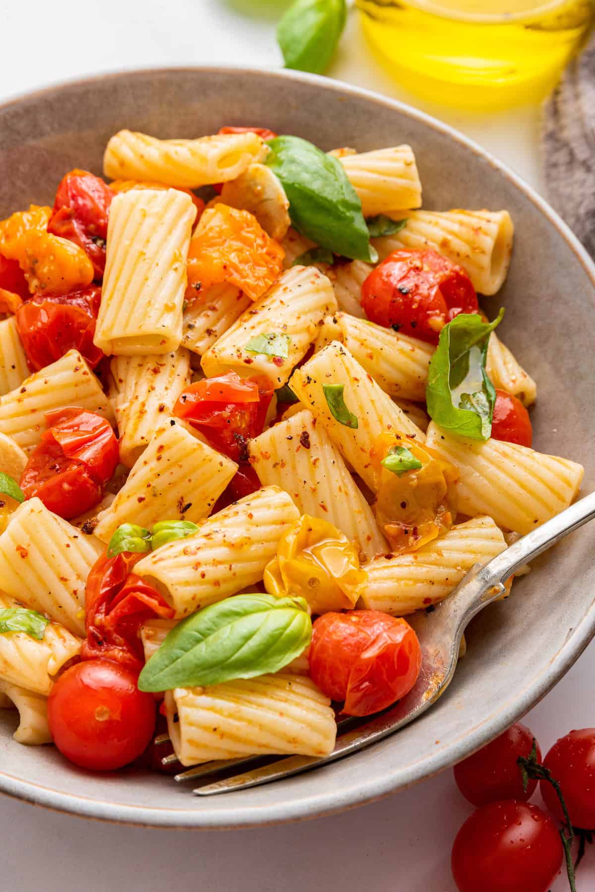 Simple cherry tomato pasta in bowl with fork