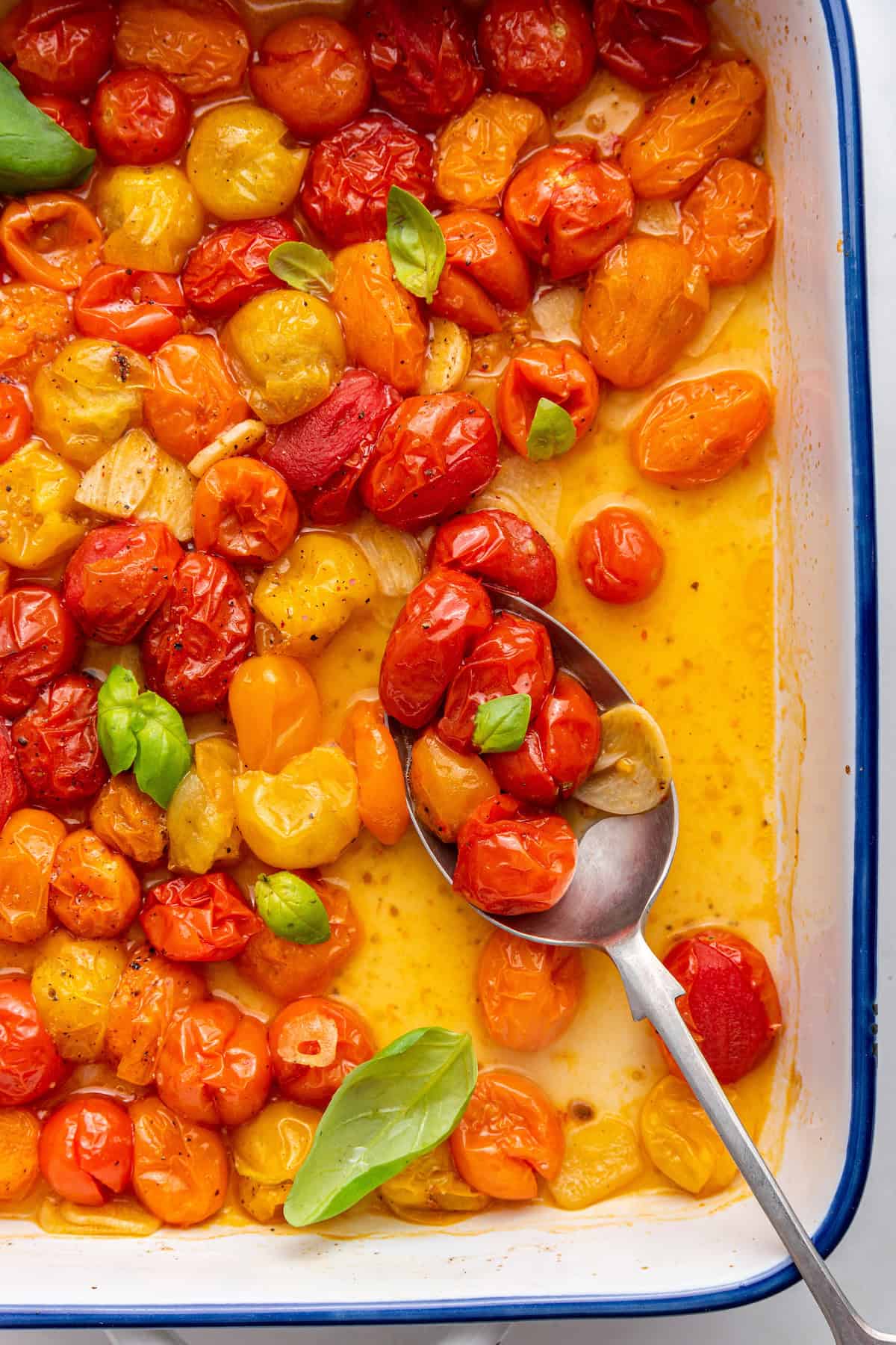 Roasted cherry tomatoes with garlic in baking pan