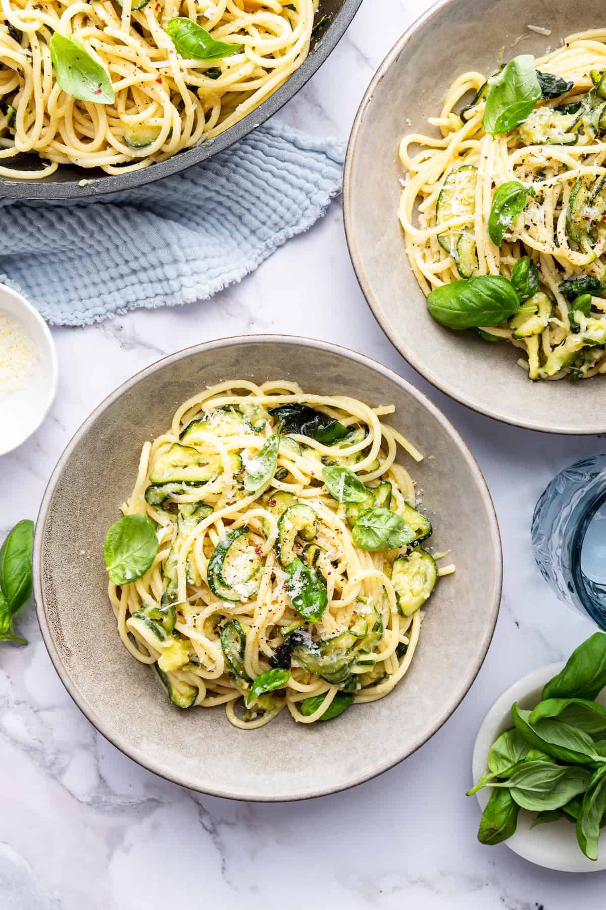 Bowls of spaghetti alla Nerano with fresh basil