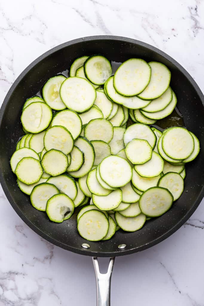 Overhead view of raw zucchini in skillet