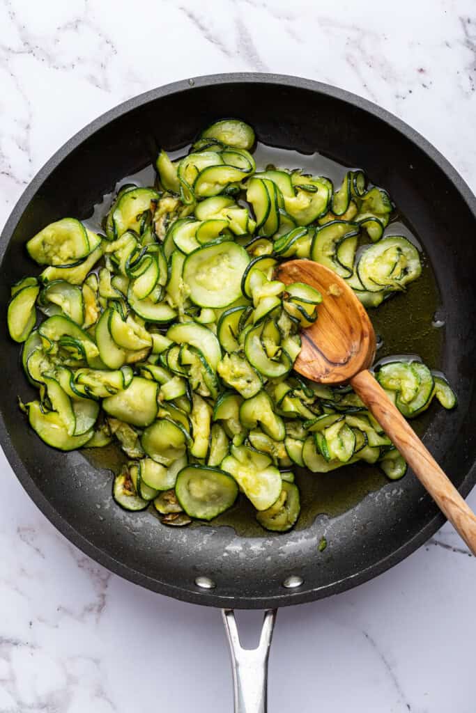 Stirring zucchini in skillet