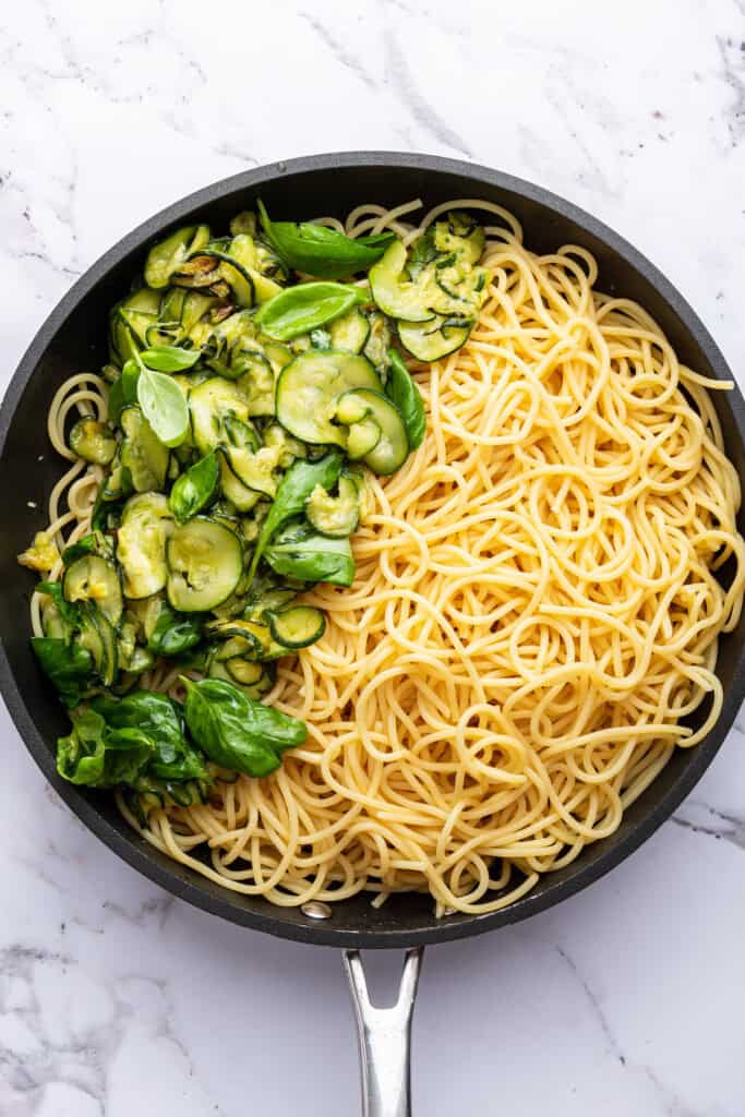 Zucchini, basil, and spaghetti in skillet