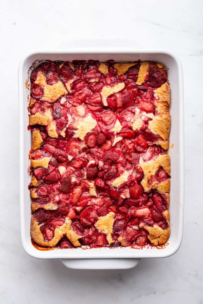 Overhead view of strawberry cobbler in baking dish