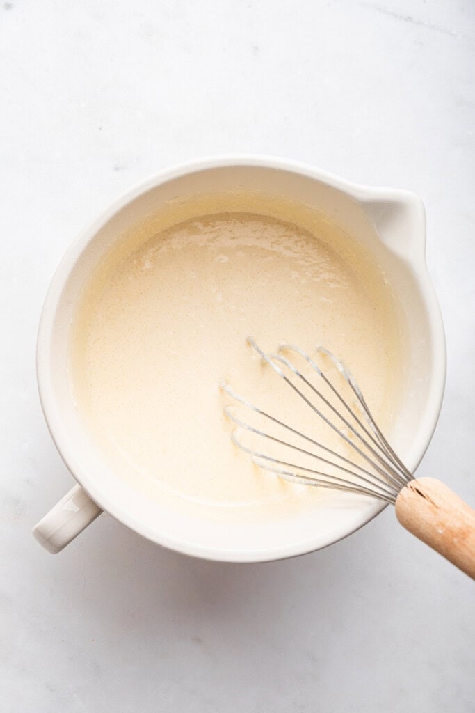 Overhead view of batter in mixing bowl with whisk