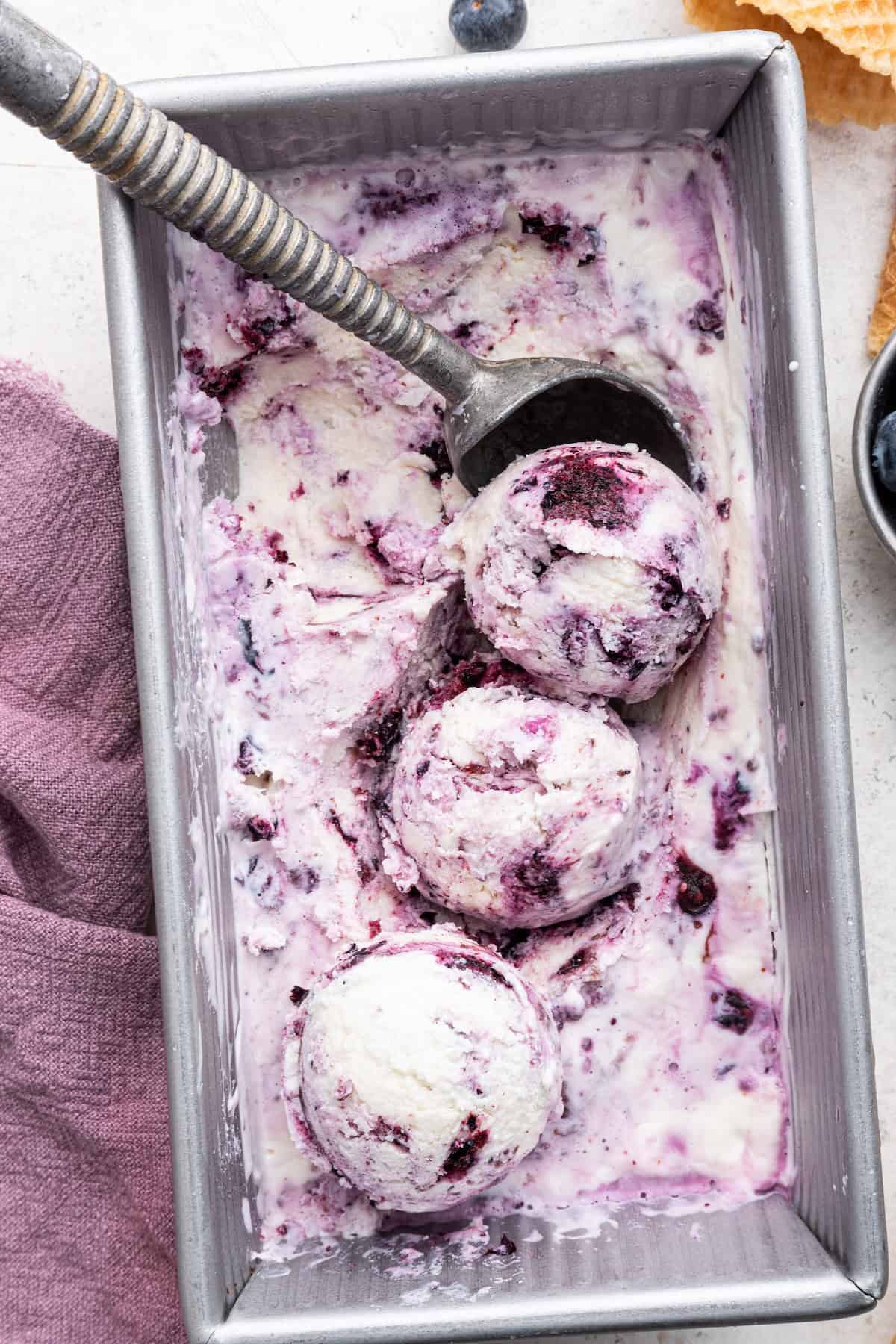 Overhead view of cottage cheese ice cream in loaf pan with scooper