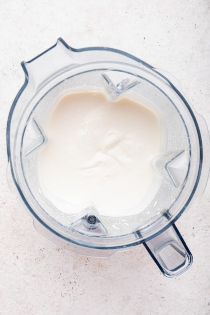 Overhead view of cottage cheese ice cream base in blender