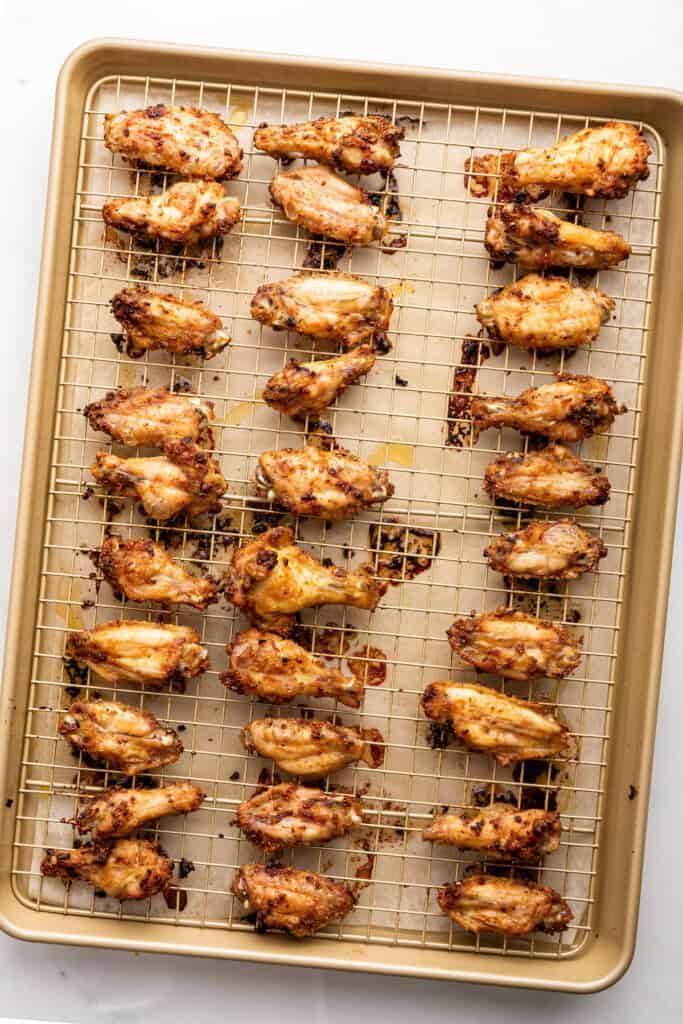 Overhead view of lemon pepper wings on wire rack